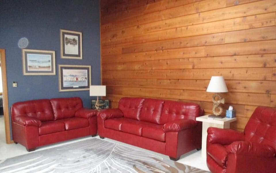 Comfortable Living Room w/ Vaulted Ceilings, Skylight, & Double Paned Fireplace