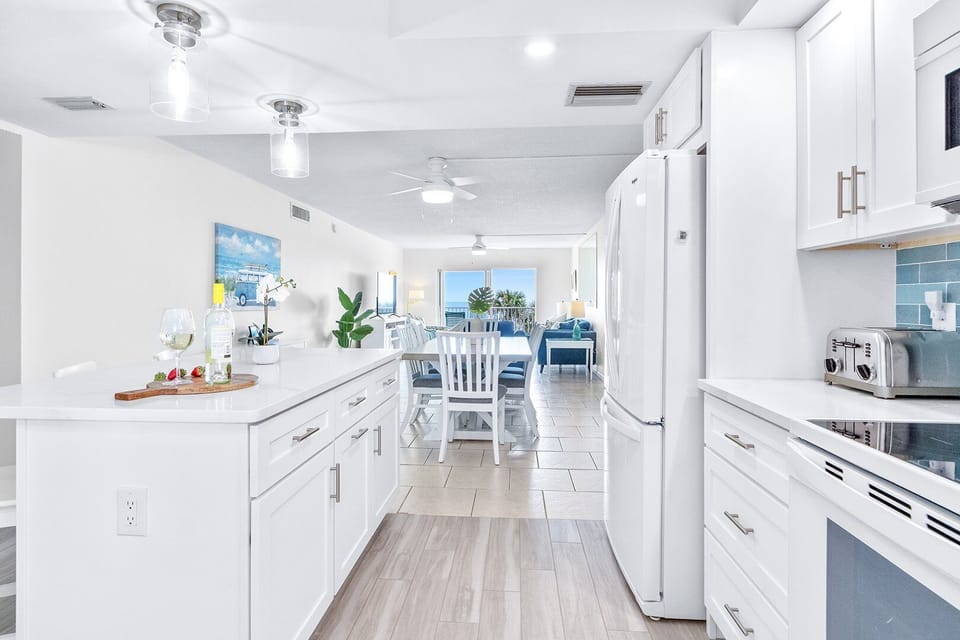 Gather round the bright kitchen while the chef cooks.