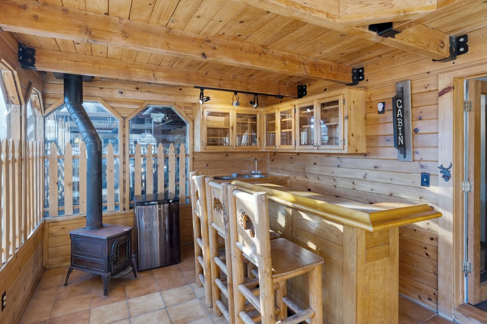 Sip drinks at the rustic wooden bar.
