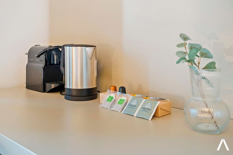  Desk space with a coffee maker and kettle for added convenience.