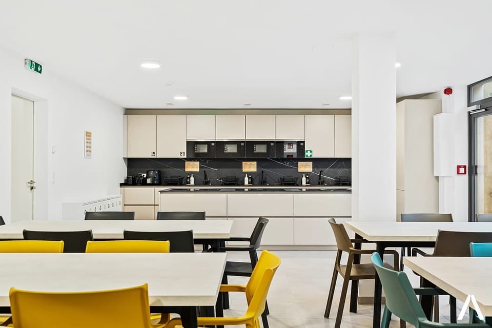 Shared Dining Area – Enjoy meals or gatherings in this chic dining space with comfortable seating for all residents.