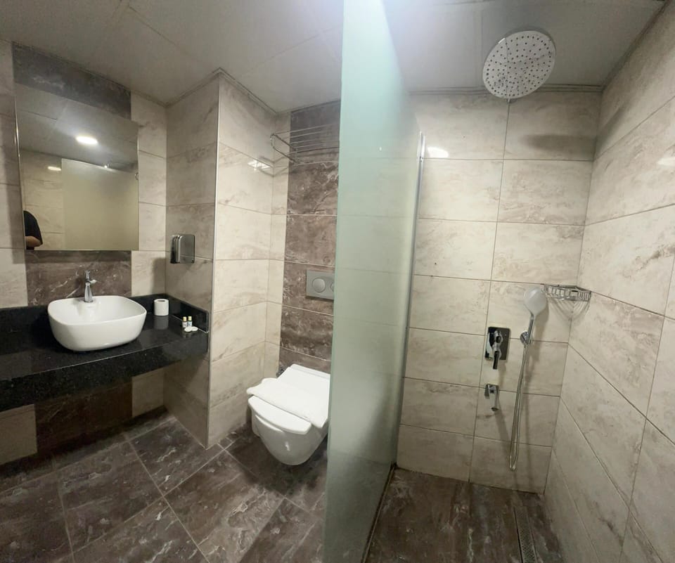 Shower, hair dryer, slippers, towels