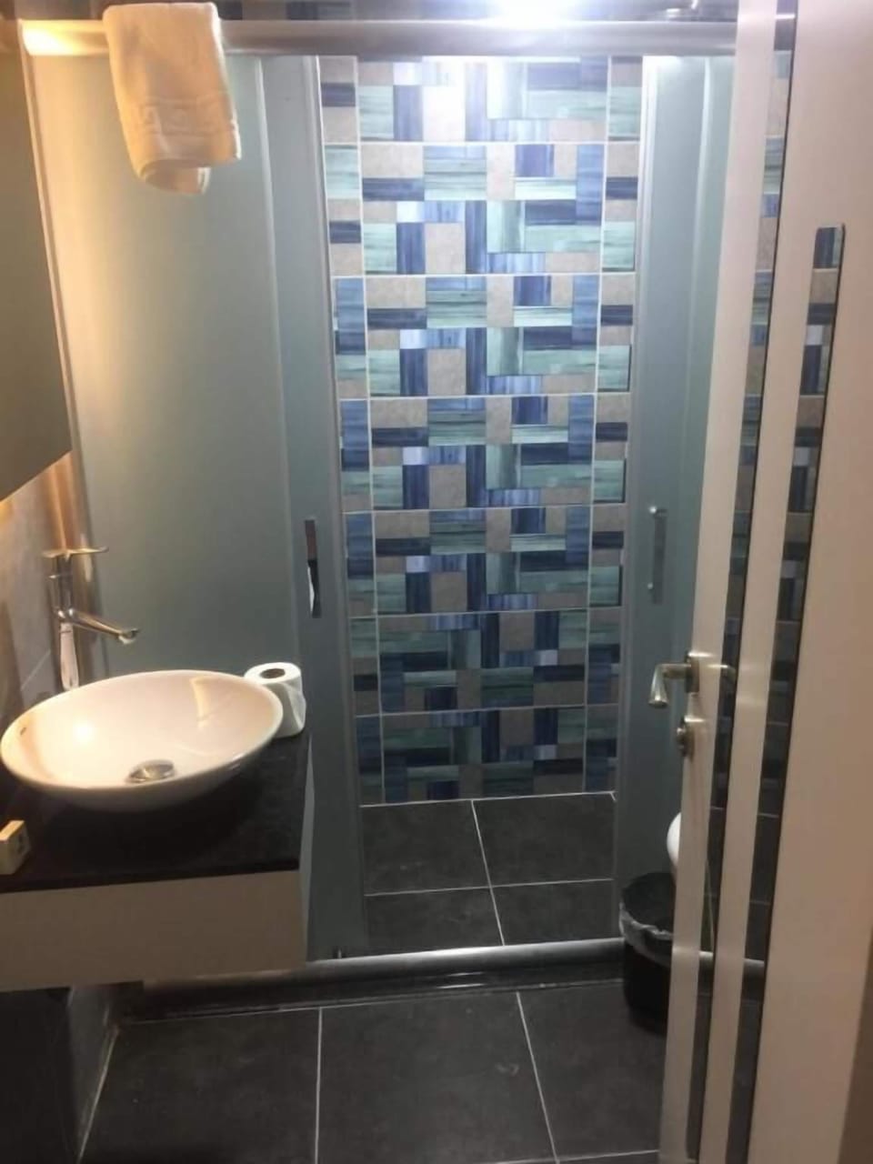 Shower, hair dryer, slippers, towels