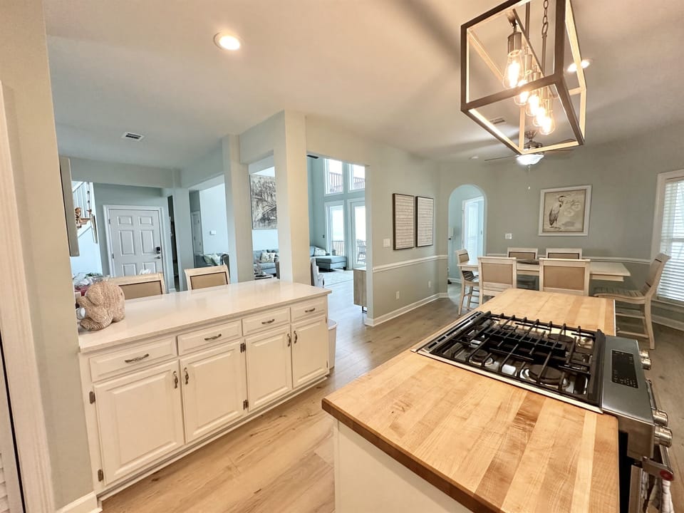 Kitchen with butcher block island and gas stove