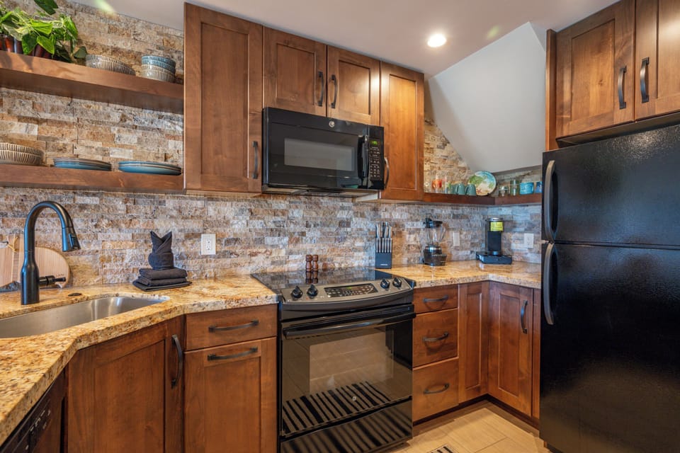 Fully stocked kitchen with serviceware, dishware, pots & pans.