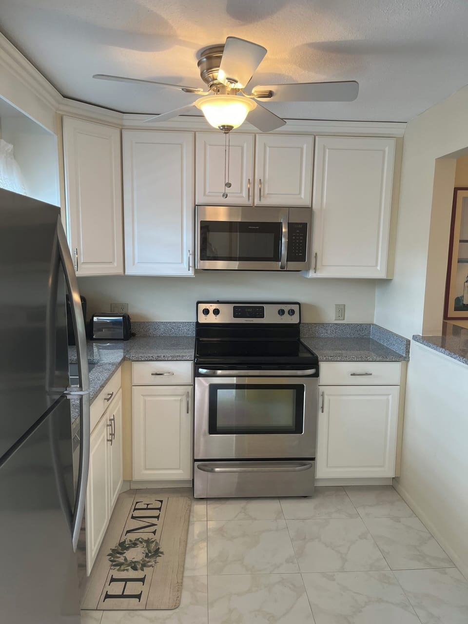 Updated kitchen with granite counters and stainless steel appliances.