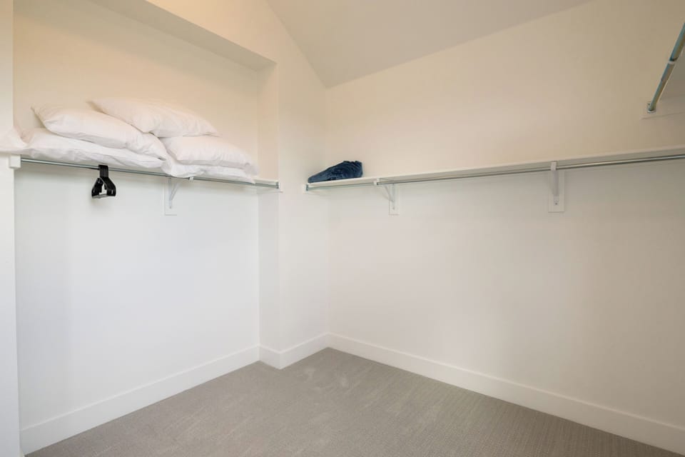 Primary bedroom has a large walk-in closet with extra pillows available for use