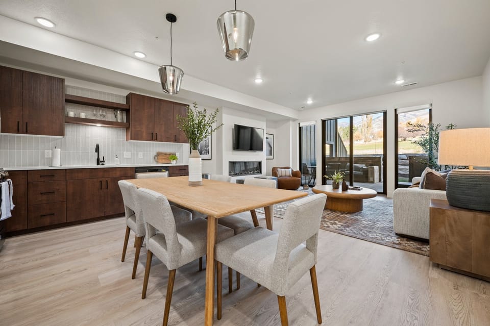The open-concept living space, complete with a dining area, facilitates effortless conversation with family and friends.