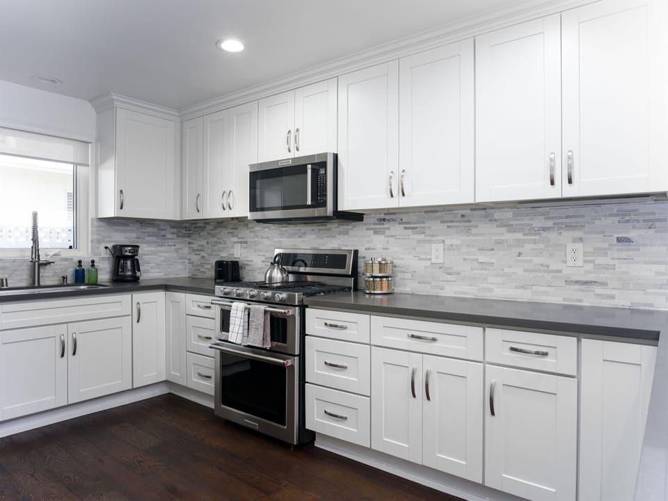 Fully equipped modern kitchen with island seating, coffee bar, and meal prep space