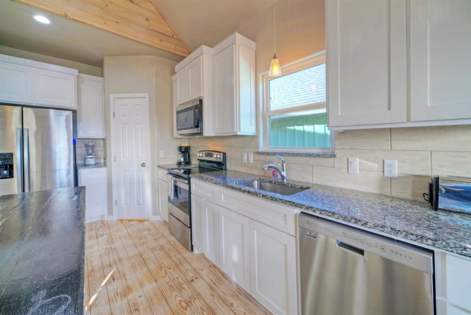 Kitchen is fully equipped and features stainless steel appliances.