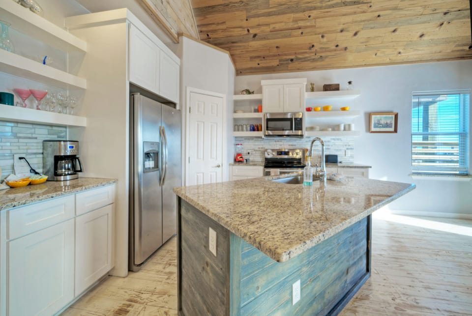 Kitchen features stainless-steel appliances.