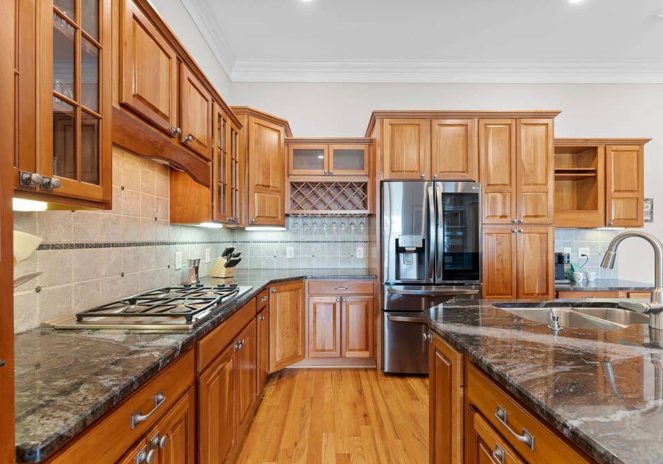 Large kitchen with island and new appliances. 