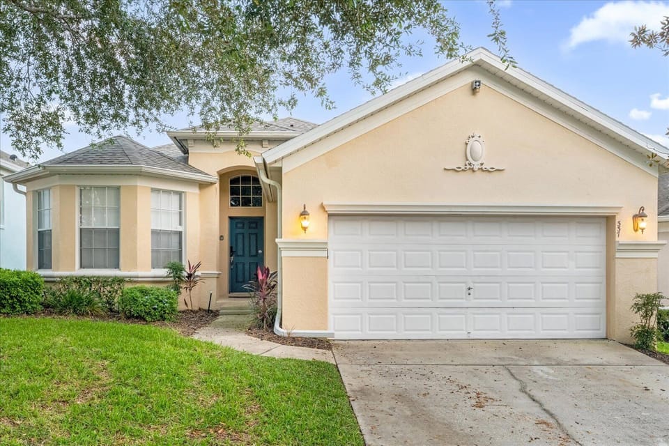 Charming villa with a welcoming facade and spacious garage, perfect for a relaxing getaway.