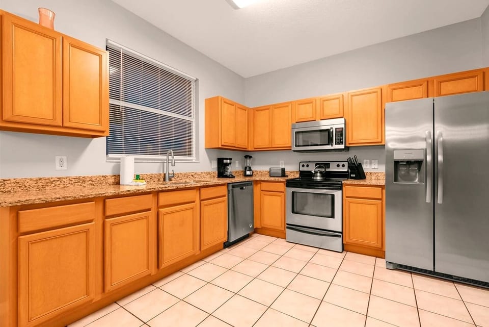 Spacious kitchen with modern appliances and ample counter space, perfect for family meals and gatherings.