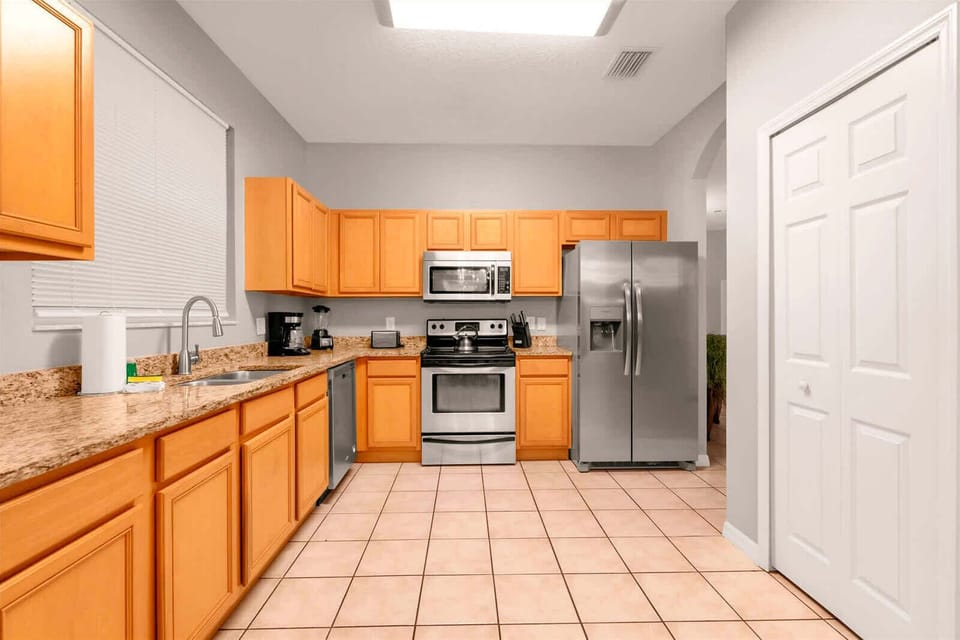 Spacious kitchen with modern appliances and ample counter space, perfect for preparing family meals.