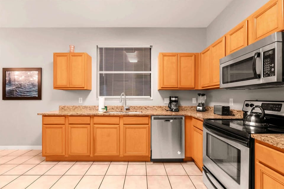 Spacious kitchen with modern appliances and ample counter space, perfect for family meals and entertaining.