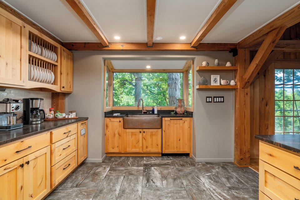 Copper sink overlooks lake in kitchen