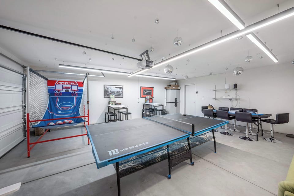 Stacked game room featuring ping pong table, basketball hoop, poker table, and board game