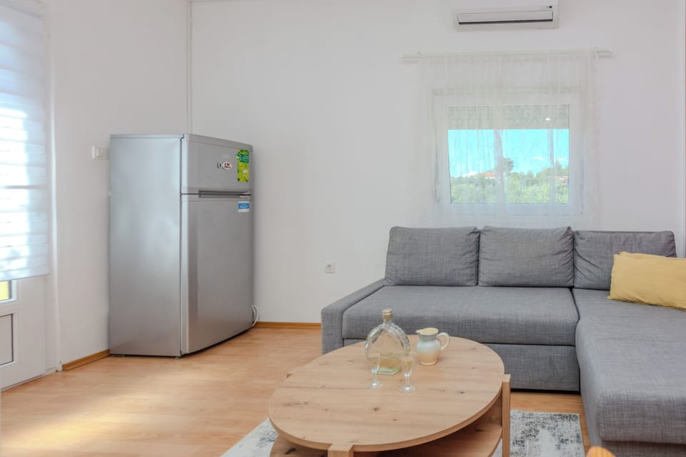 Comfort Apartment, Partial Sea View | Living area | 100-cm flat-screen TV with satellite channels