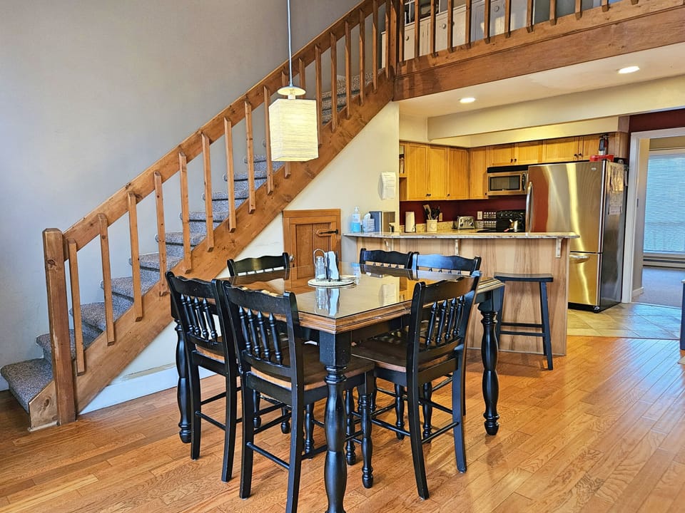 Dining/kitchen area with bunkroom beyond