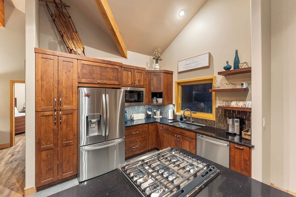 Full kitchen featuring all stainless steel appliances, air fryer, and five-burner stovetop.