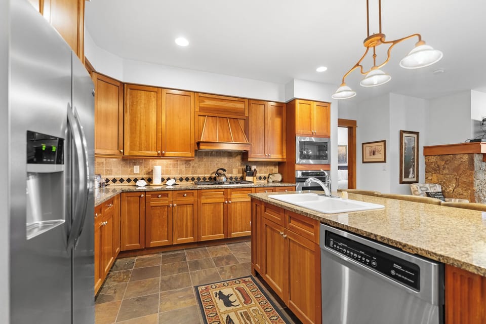 Your spacious kitchen features granite counters, warm wood cabinets, and modern appliances—perfect for preparing memorable meals together.