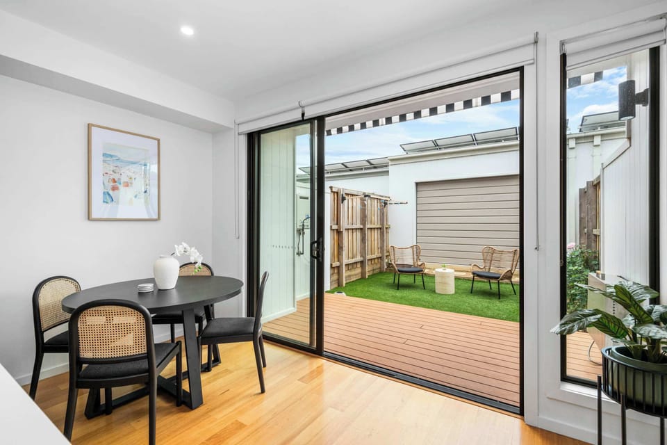 Open-plan dining leading to outdoor decking area.