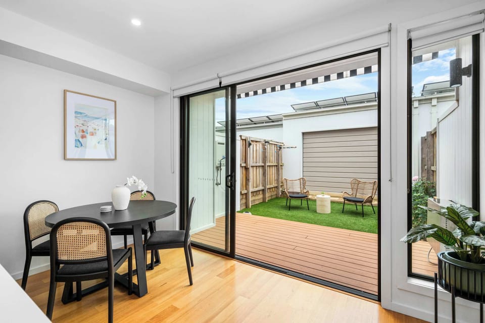 Open-plan dining leading to outdoor decking area.