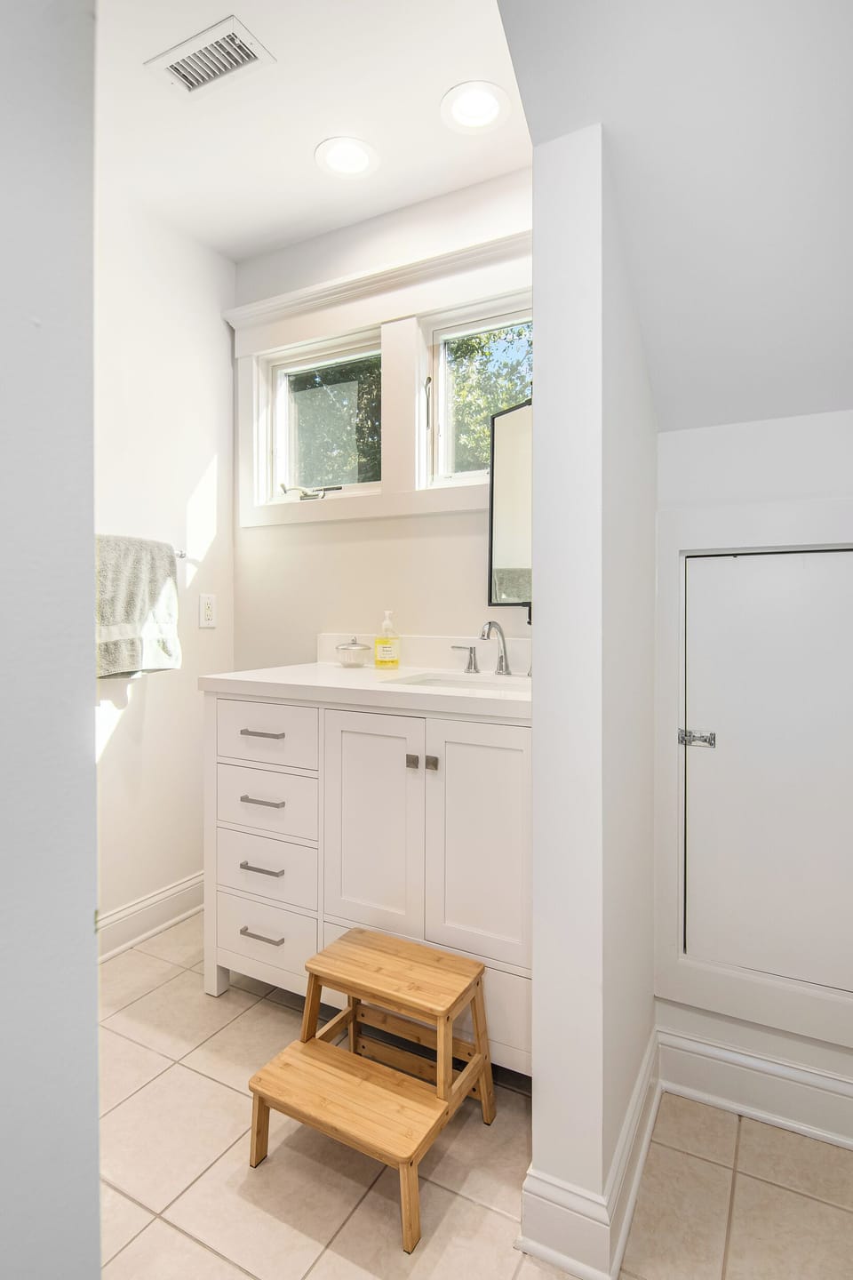 The bathroom attached to the bunk room is equipped with a stool to make it accessible for all ages.