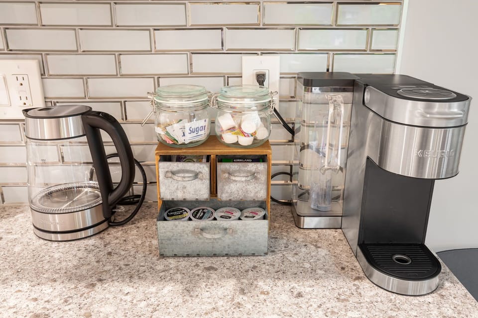 The kitchen features a Keurig and tea station. Morning rituals made easy — just add sunshine.