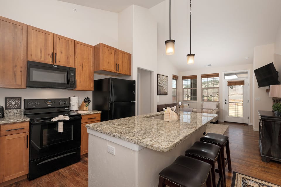 Your open kitchen flows seamlessly into the living area, featuring granite countertops and modern appliances for memorable home-cooked meals together.