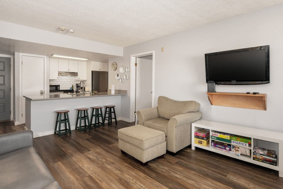 Your open-plan space flows seamlessly from kitchen to living room, perfect for relaxing with a movie after cooking. at Summit Unit 1103
