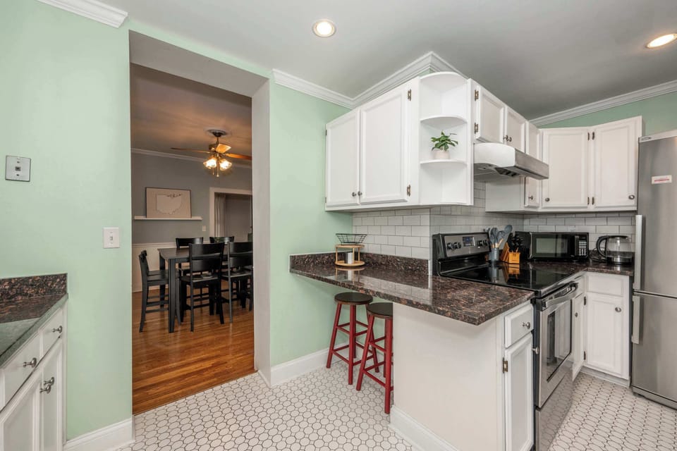 The bright, airy kitchen offers ample space & all the comforts of home