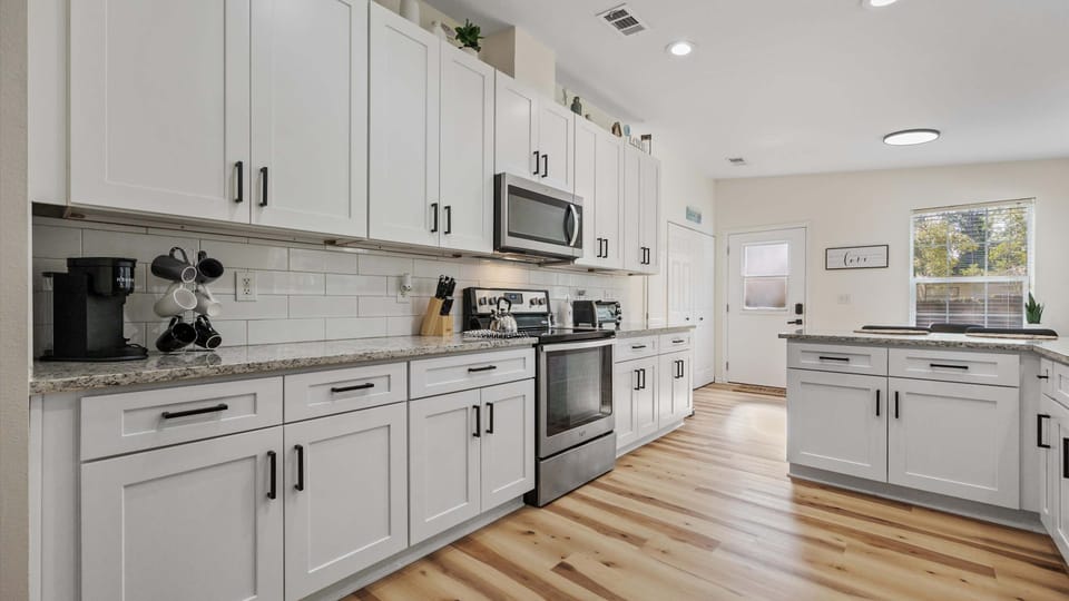 The airy, updated kitchen offers ample space & all the comforts of home