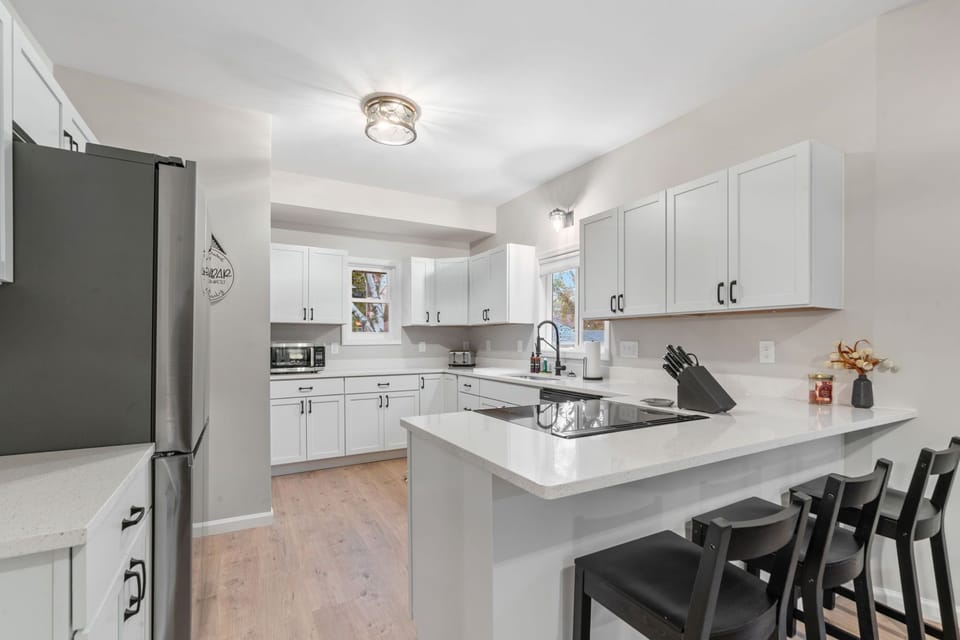 Cook together in this bright, fully-equipped kitchen with modern appliances and island seating for memorable meals.