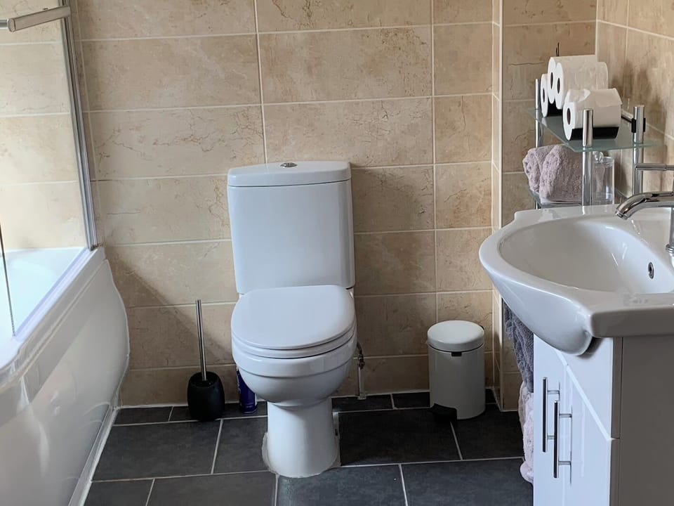 Bathroom with bath and shower over. 