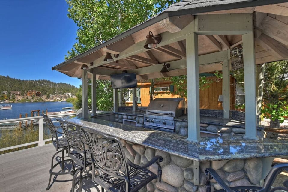 Outdoor lakefront deck outfitted with you own personal bar area complete with a BBQ and cooking area.