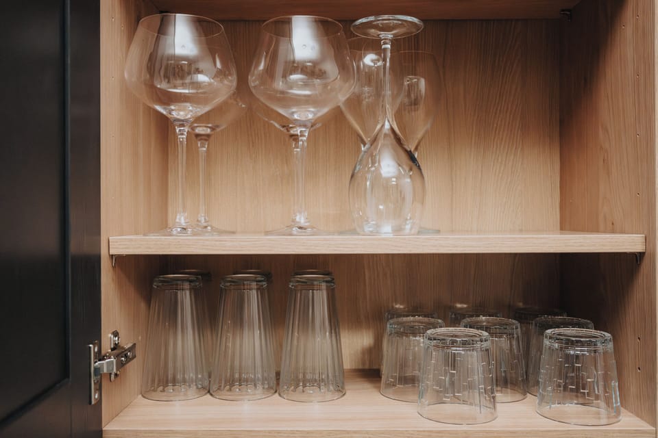 Elegantly arranged cabinet with glassware and refined wine glasses—ideal for celebratory toasts or savouring your favourite vintage.