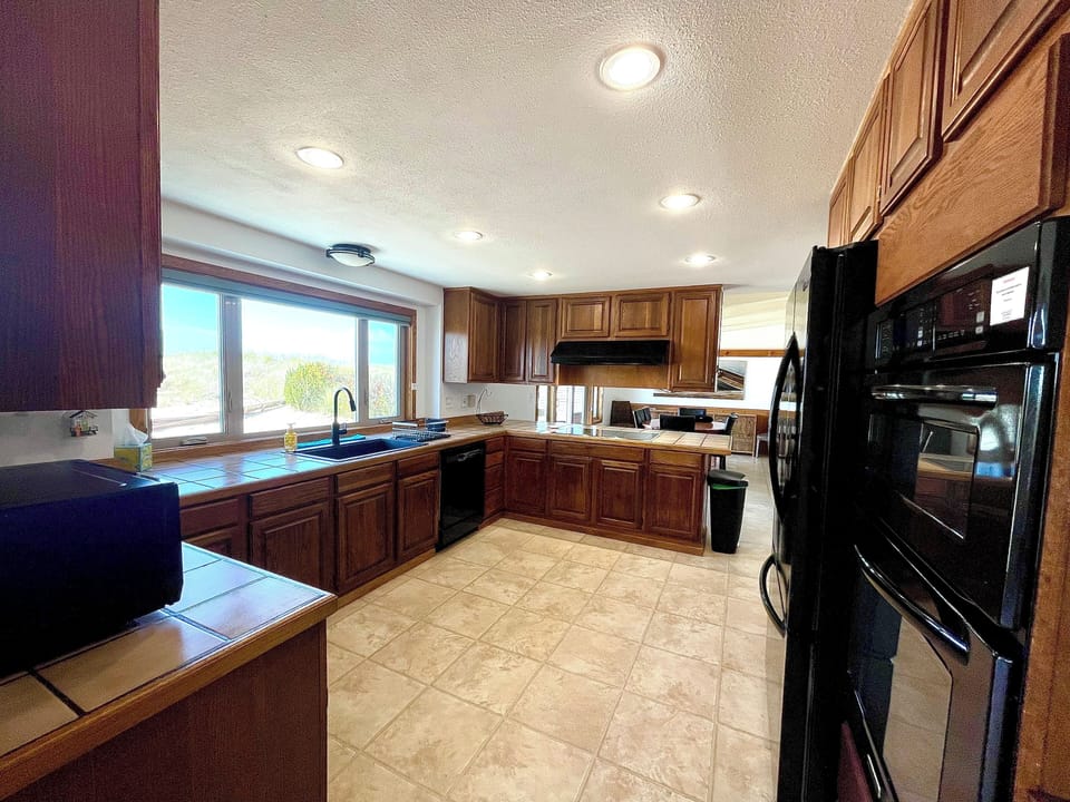 Kitchen with 5-burner electric cooktop, coffee bar and more.