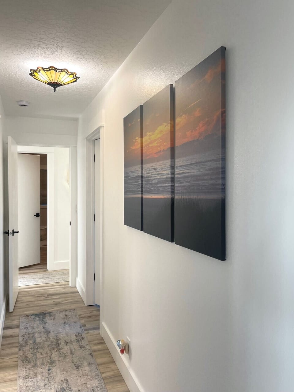 Hallway provides access to bedroom 3 and bathroom 3 across the way.