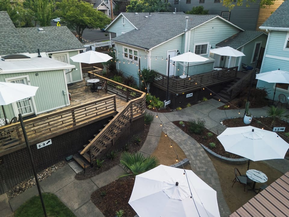 Aerial view of the property courtyard with outdoor decks, tables, and parasols.