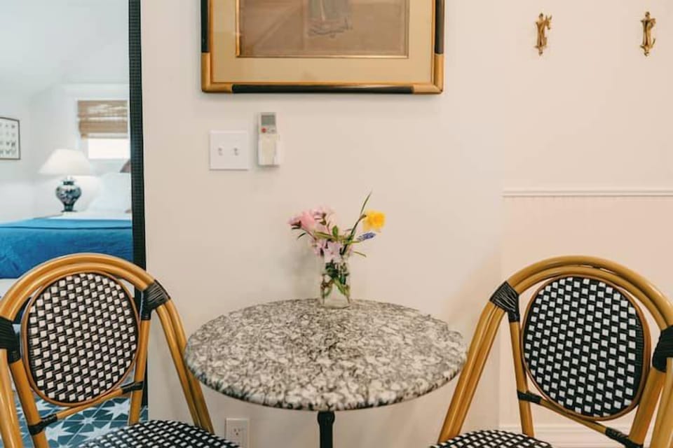 Swank 2: Intimate bistro dining setup for two, perfect for enjoying morning coffee or quiet meals.