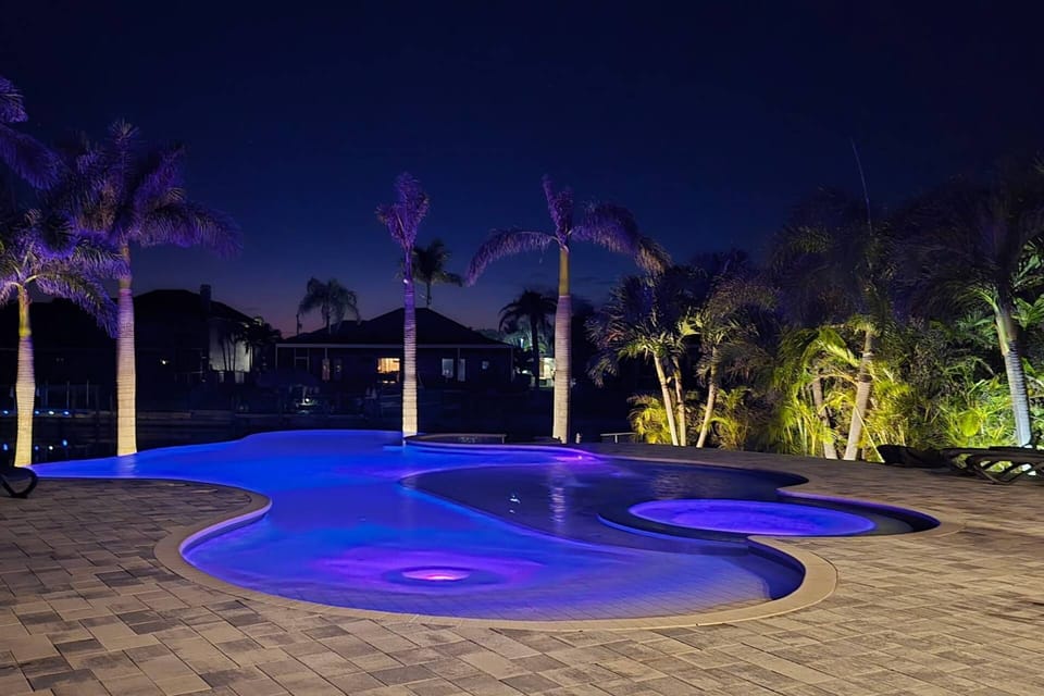 Nighttime brings a whole new - and equally beautiful - mood to the pool, back of the home and waterfront.