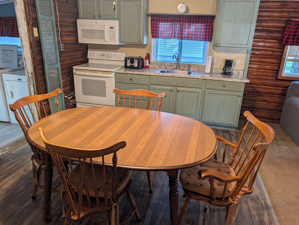 DINING AREA:  There is a cute dining table with seating for 4 adults in the middle of the kitchen.