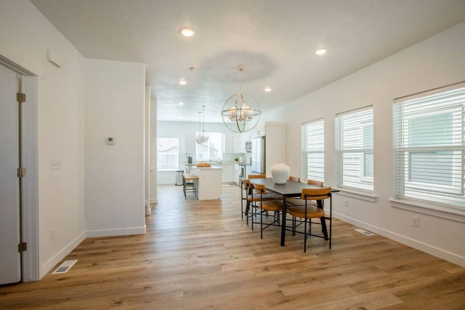 The combination of natural light, soft tones, and minimalist design makes this dining area ideal for relaxing dinners or remote work sessions with style.