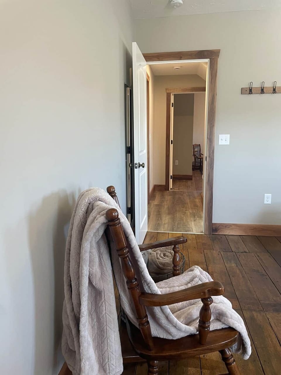 Looking into the short upstairs hallway. Bathroom three is on the right and bedroom three is at the end of the hallway with the staircase beside it. 