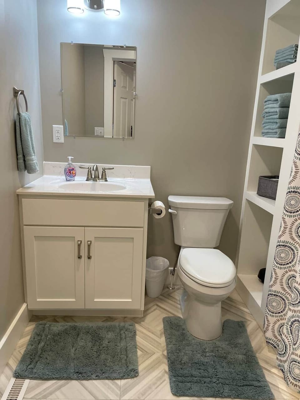 Bathroom two includes toilet, sink and shower