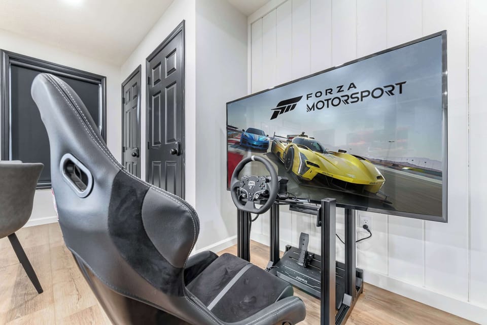 Enjoy immersive racing with this dedicated gaming setup featuring a racing wheel and pedals.