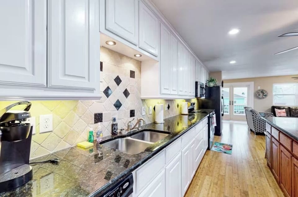 Cook in comfort in a well-lit, airy kitchen stocked with everything for a  meal!