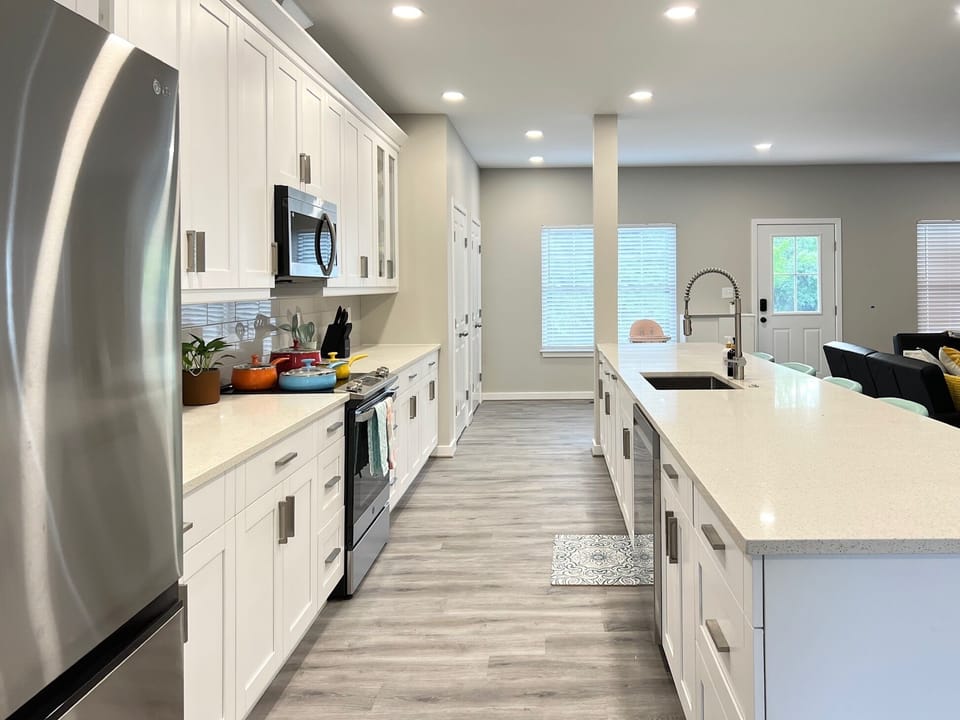 The kitchen has microwave, stove/oven, refrigerator, dishwasher, and disposal.
